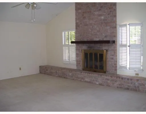 a view of empty room with a fireplace