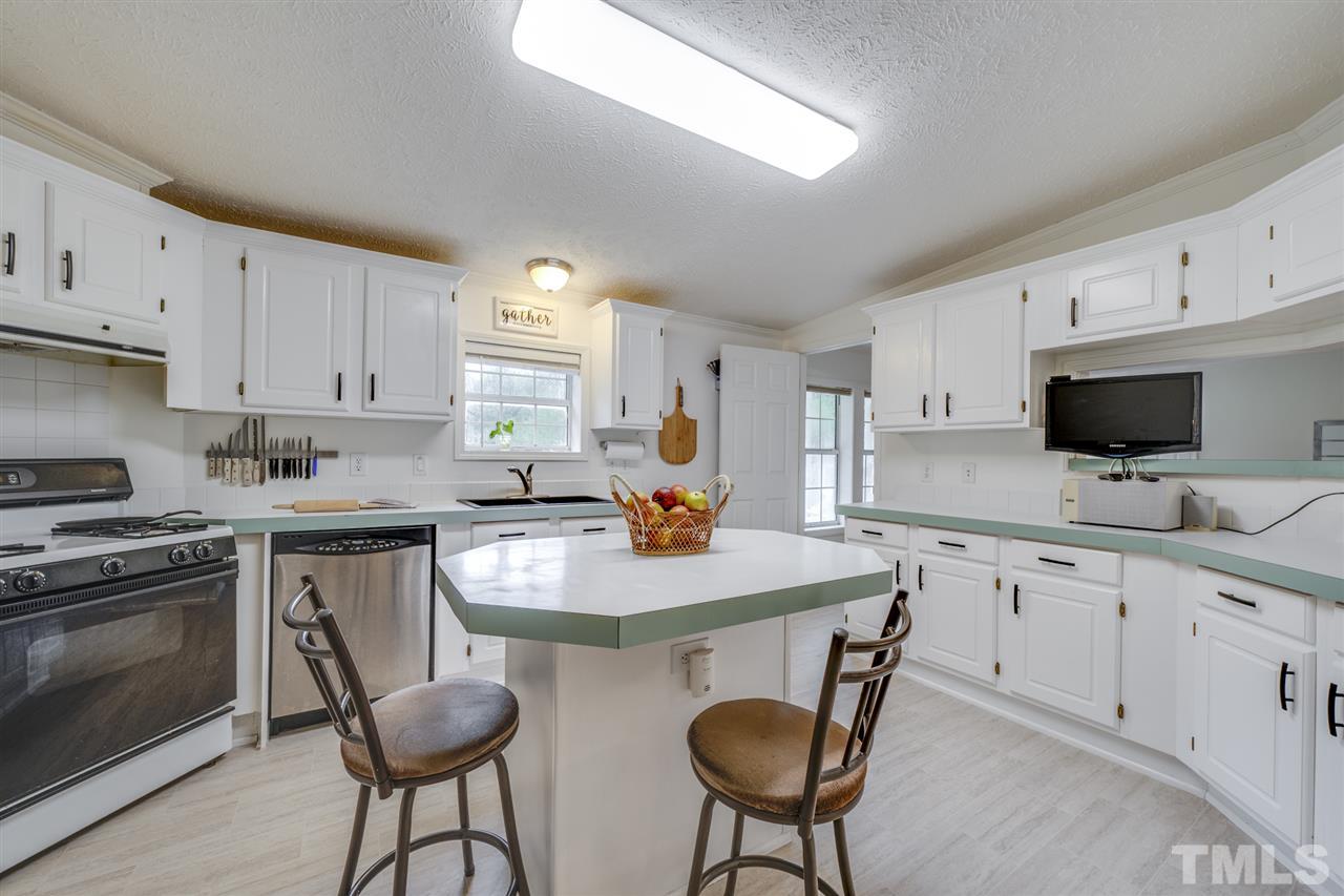 3089 Rock Spring Church Road Creedmoor, NC 27522 - Photo 6 of 30 Spacious Kitchen with new vinyl flooring. Lots of cabinets! Center island