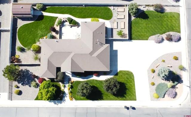 an aerial view of a house with a garden and a car parked