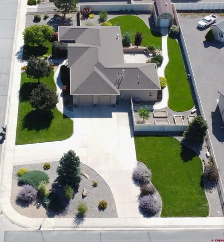 an aerial view of a house with a yard and potted plants