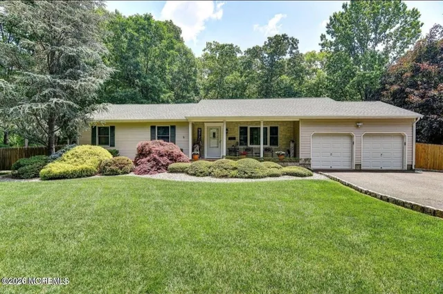 a front view of a house with a yard and porch