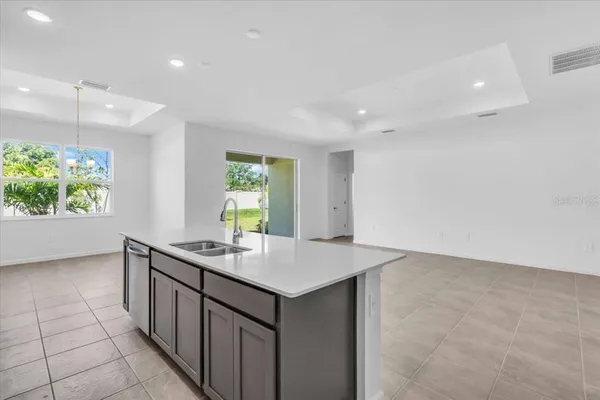 a kitchen with a sink a window and a counter top space