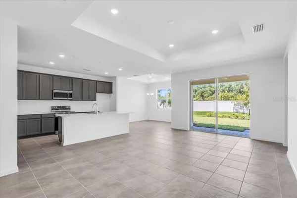 a large white kitchen with a large window