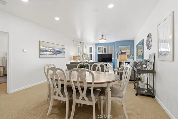 a view of a dining room with furniture and a potted plant