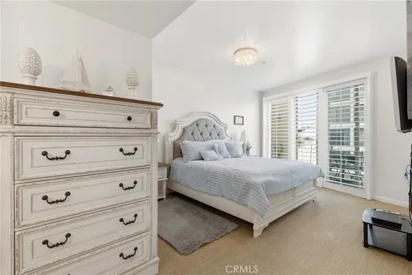 a bedroom with a bed and a night stand