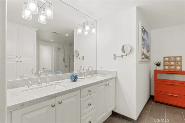 a bathroom with a double vanity sink and a mirror
