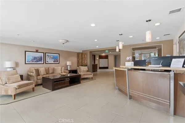 a living room with stainless steel appliances kitchen island furniture and a view of kitchen