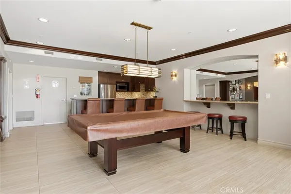 a large kitchen with kitchen island granite countertop a large counter top appliances and cabinets
