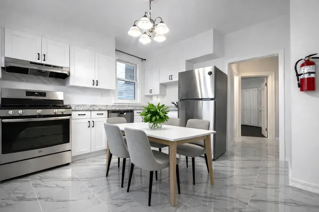 a kitchen with stainless steel appliances a stove a sink island and a refrigerator