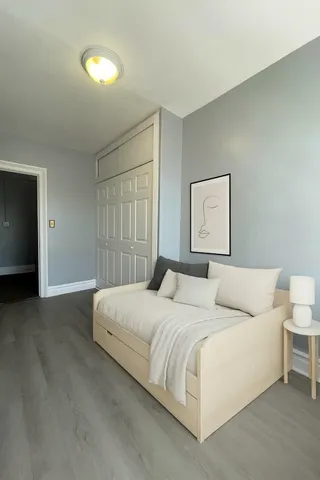 a bedroom with a bed and a night stand