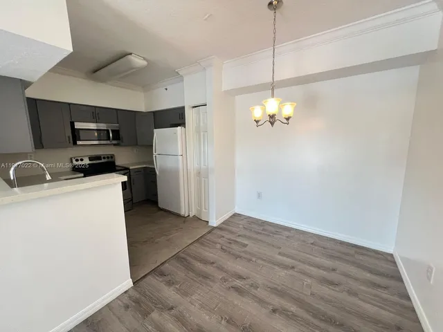 a kitchen with refrigerator and microwave