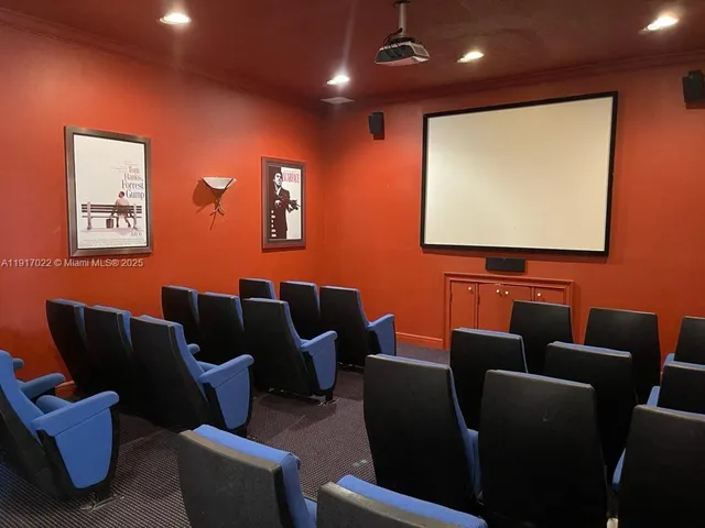a media room with lots of chairs and a projector screen