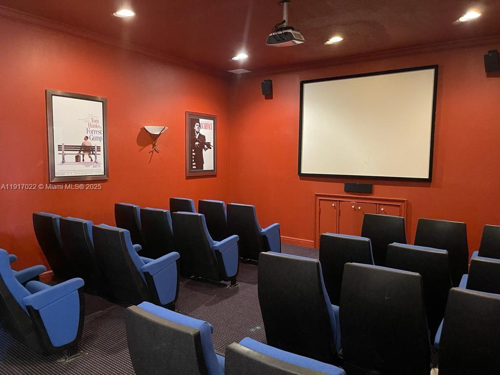 101 Southwest 117th Avenue, Unit 7206 Pembroke Pines, FL 33025 - Photo 10 of 12 a media room with lots of chairs and a projector screen