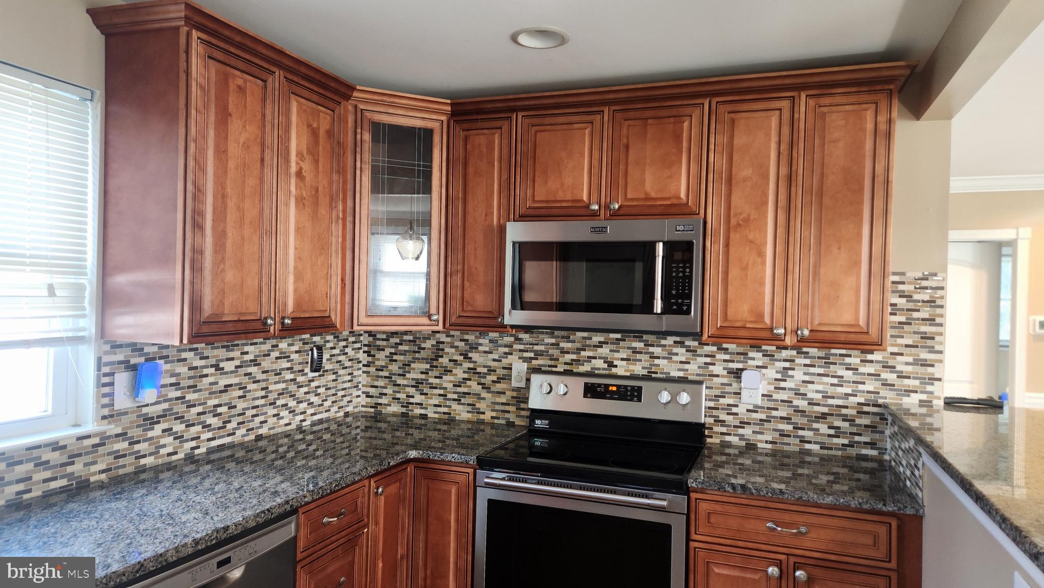 18601 Johnson Road Lincoln, DE 19960 - Photo 5 of 15 a kitchen with granite countertop a stove sink and microwave