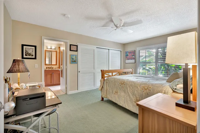 a spacious bedroom with a bed and wooden floor