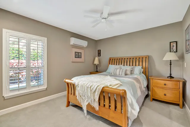 a spacious bedroom with a bed and a night stand