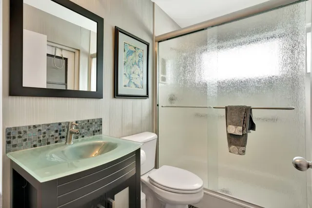 a bathroom with a sink toilet and shower