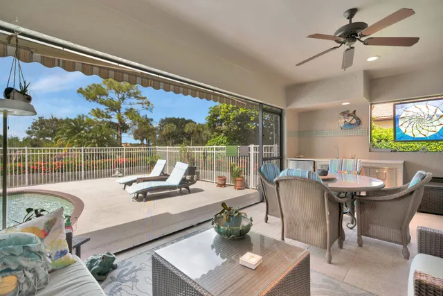 a view of a dining room with furniture a chandelier and window