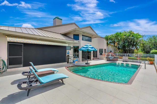 a view of a backyard with sitting area