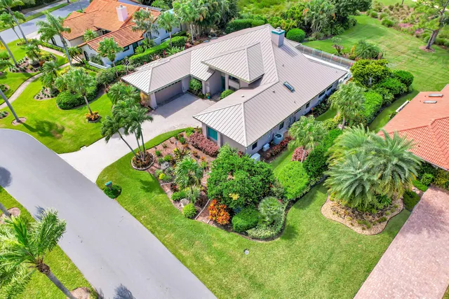 an aerial view of a house with a garden and plants