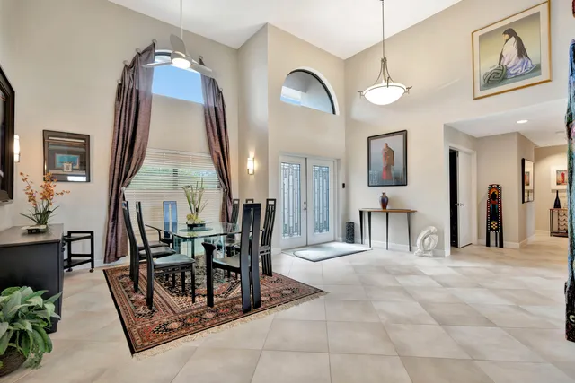 a view of a livingroom with furniture and a large mirror