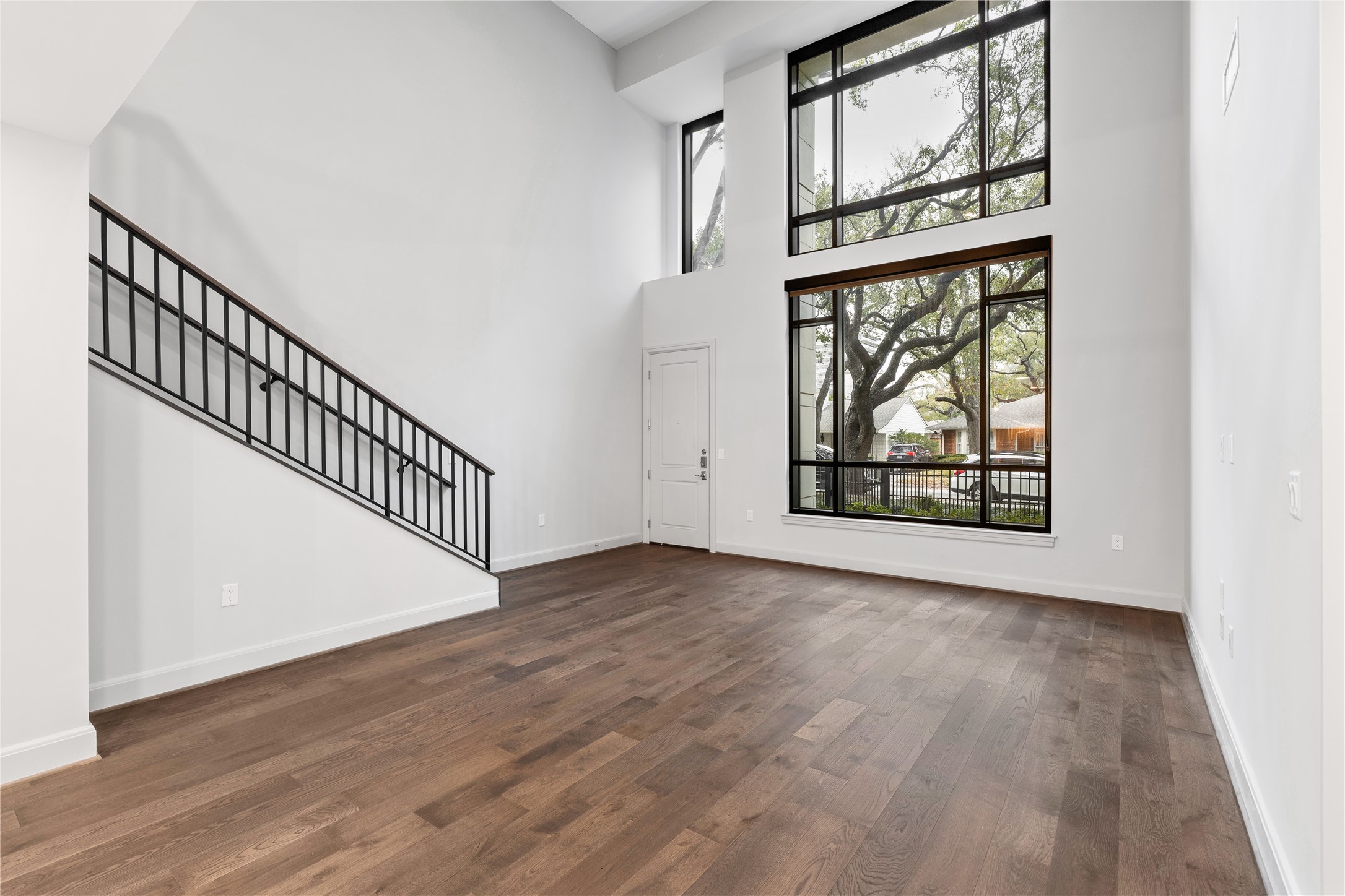 2511 Willowick Road, Unit 117 Houston, TX 77027 - Photo 1 of 43 an empty room with wooden floor windows and entryway
