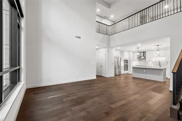 a view of a kitchen with wooden floor and a sink