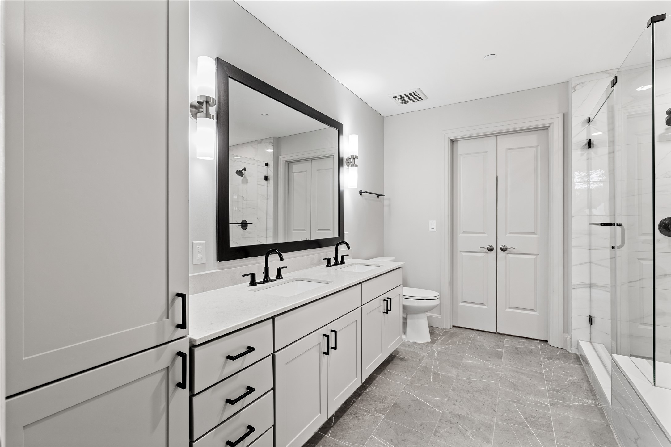 2511 Willowick Road, Unit 117 Houston, TX 77027 - Photo 17 of 43 a spacious bathroom with 2 sink and a mirror