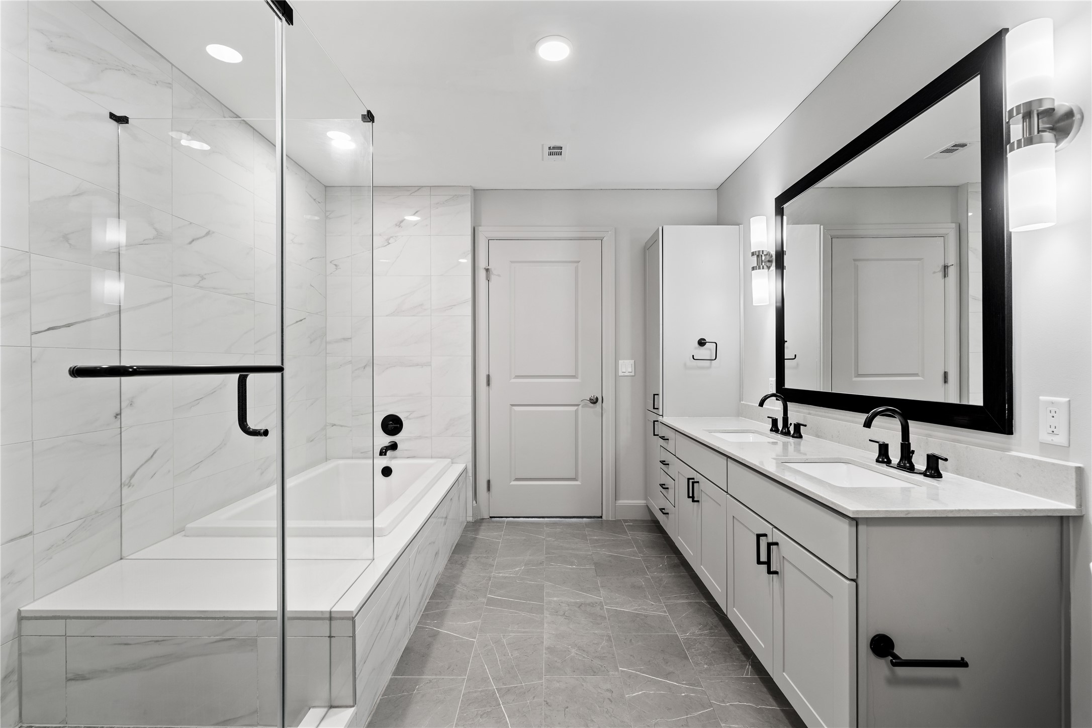 2511 Willowick Road, Unit 117 Houston, TX 77027 - Photo 18 of 43 a bathroom with a double vanity sink and mirror with shower