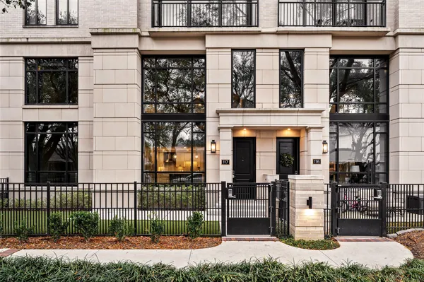 a front view of a building with a garden