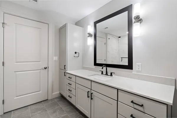 a bathroom with a double vanity sink and mirror