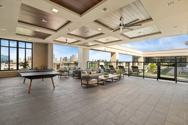 a gym room with lots of furniture and a chandelier