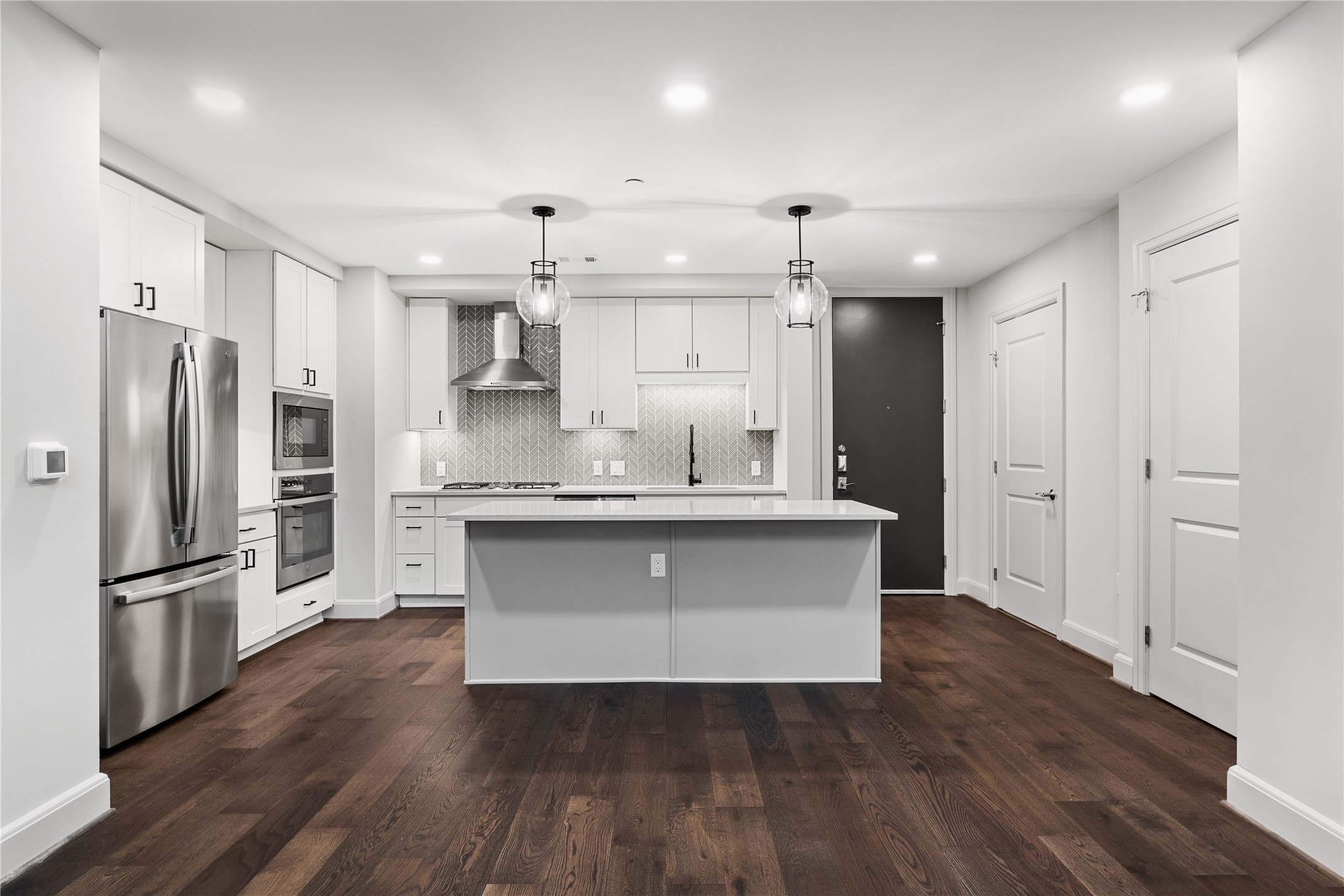 2511 Willowick Road, Unit 117 Houston, TX 77027 - Photo 9 of 43 a kitchen with granite countertop a refrigerator and a sink