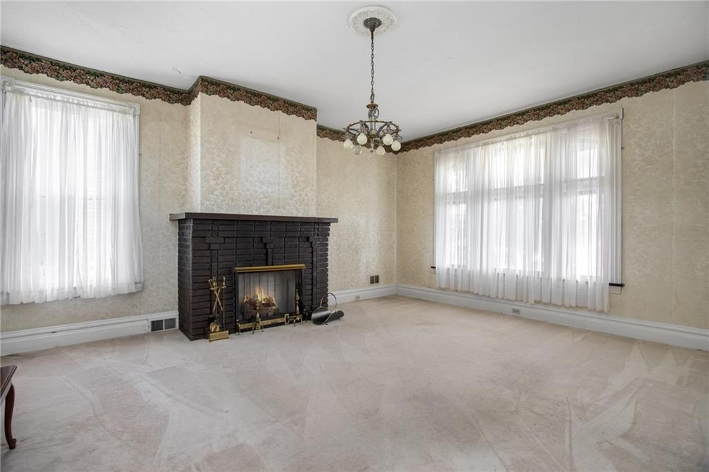 446 Pinney Street Rochester, PA 15074 - Photo 8 of 25 Impressive oversized formal living room with picture windows, high ceilings and gas fireplace