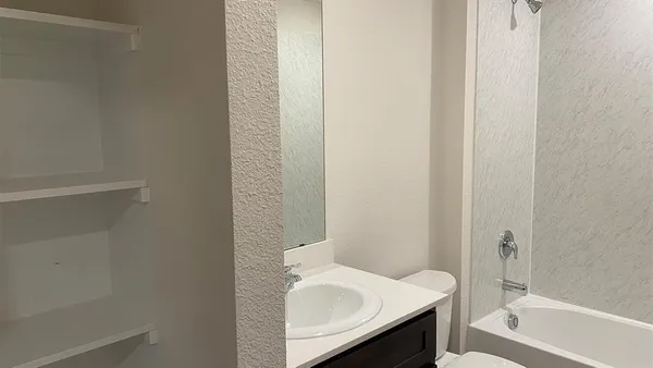 a view of hallway with wooden floor and window