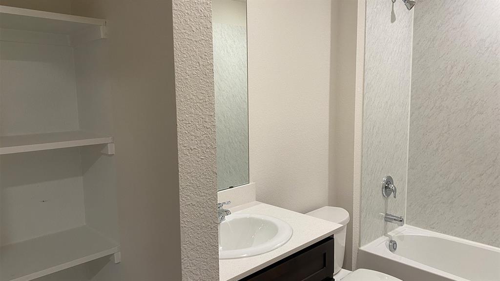 107 Hunters Way Canton, TX 75103 - Photo 11 of 23 Bathroom featuring a textured wall, vanity, and shower / tub combination