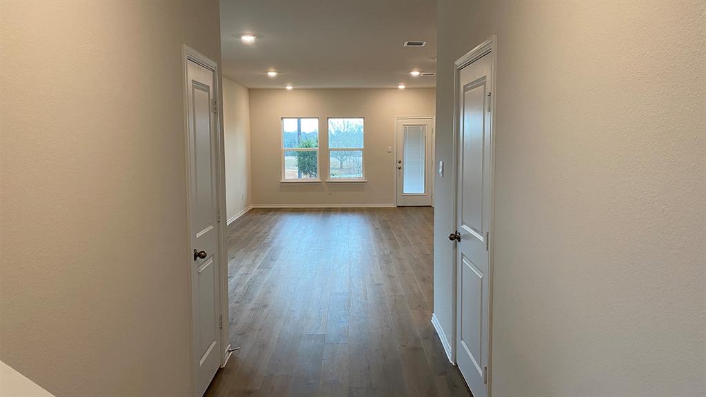 107 Hunters Way Canton, TX 75103 - Photo 12 of 23 Corridor featuring dark wood-style floors, a textured wall, and recessed lighting
