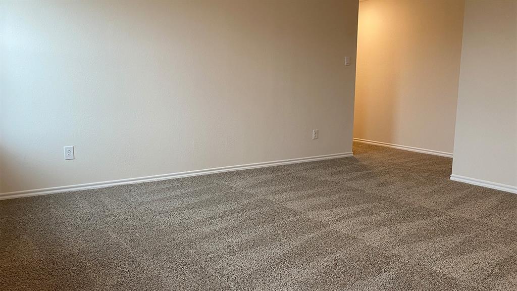 107 Hunters Way Canton, TX 75103 - Photo 15 of 23 Empty room featuring dark colored carpet and baseboards