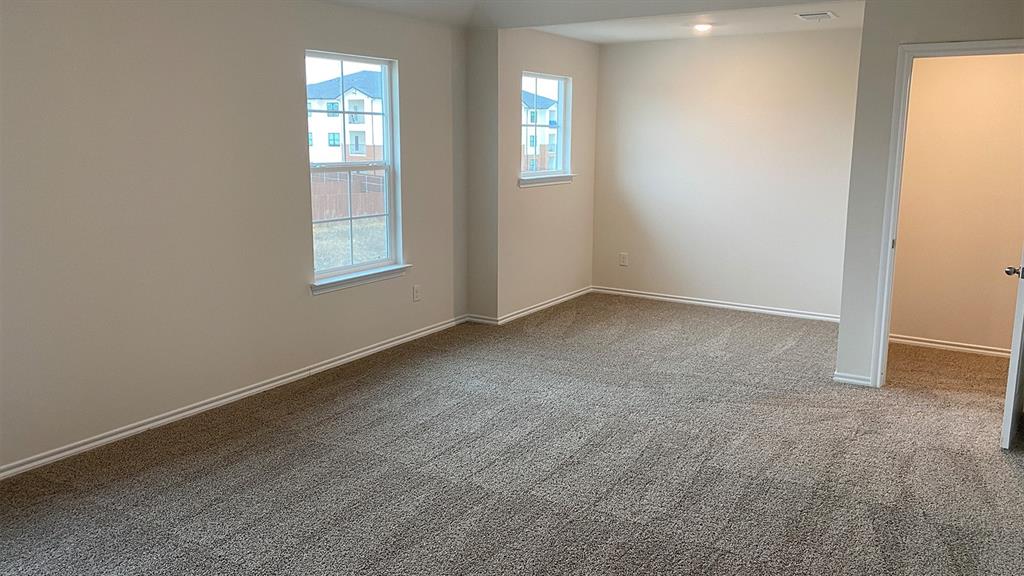 107 Hunters Way Canton, TX 75103 - Photo 17 of 23 Empty room with light colored carpet and baseboards