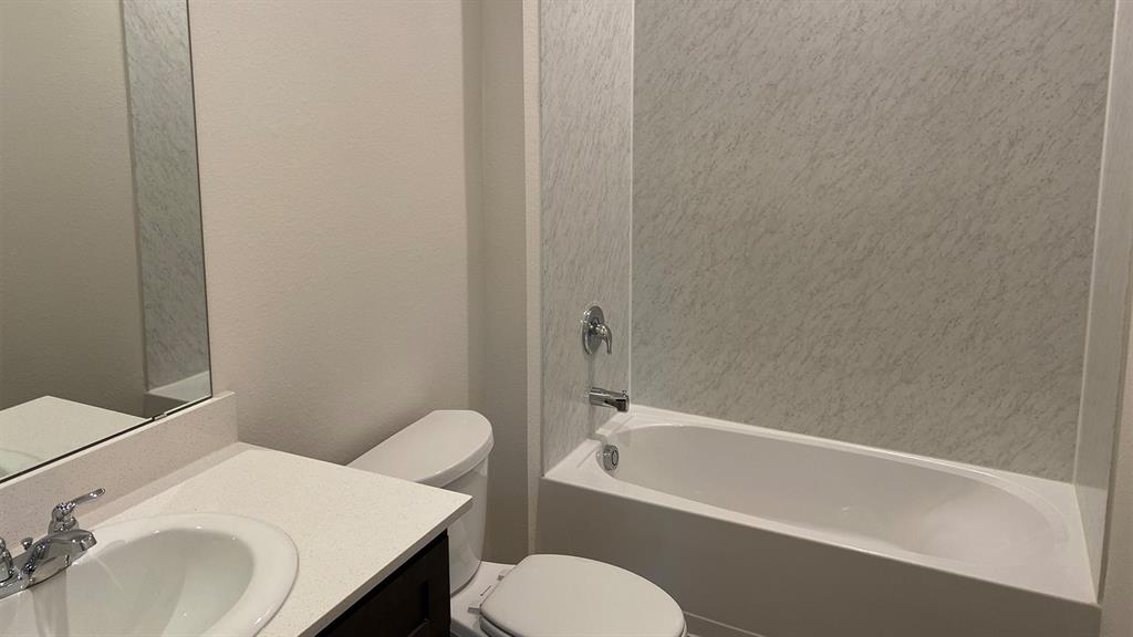 107 Hunters Way Canton, TX 75103 - Photo 6 of 23 Full bathroom featuring vanity, bathtub / shower combination, and a textured wall