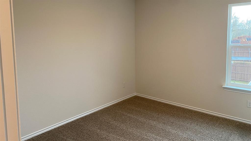 107 Hunters Way Canton, TX 75103 - Photo 8 of 23 Spare room featuring baseboards and dark carpet