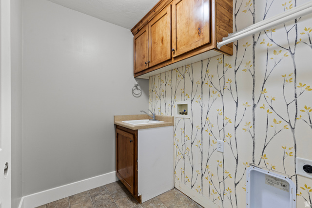 75 East 200 North Mendon, UT 84325 - Photo 20 of 36 Laundry room with cabinet space, washer hookup, wallpapered walls, and an accent wall