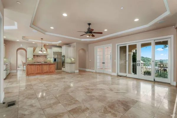 a big room with windows and chandelier