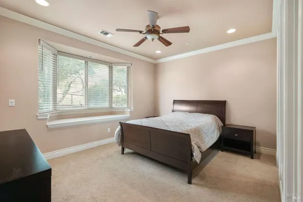 a bed sitting in a room next to a window