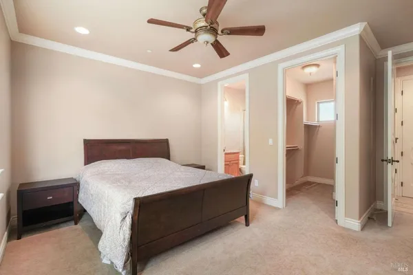 a spacious bedroom with a bed and a chandelier