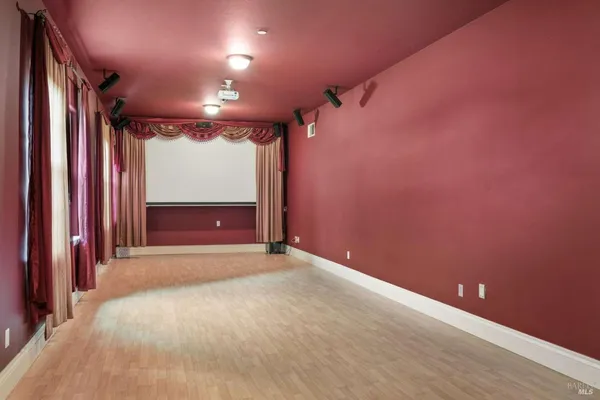 en empty room with a fireplace and a projector