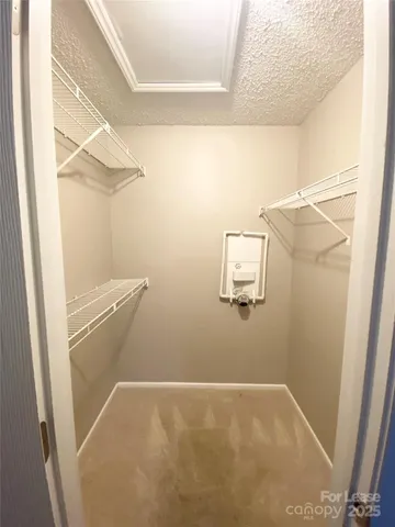 a view of storage and utility room with racks on the wall