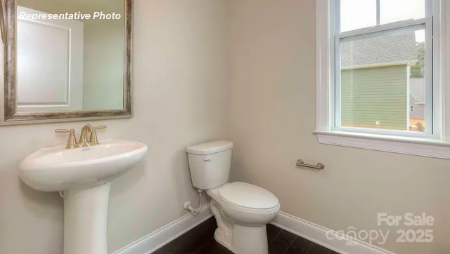 a bathroom with a sink toilet and a mirror