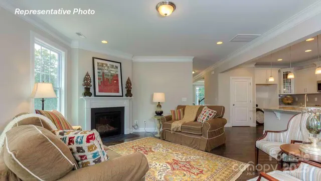 a living room with furniture fireplace and window