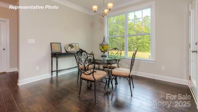 a dining room with furniture and wooden floor